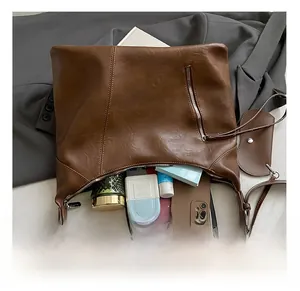 Macro view of brown leather tote bag interior showing large capacity for essentials