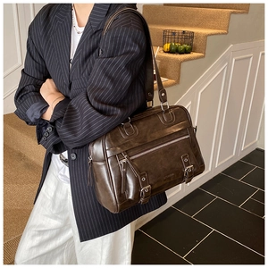 Detail of vintage coffee brown messenger bag with multiple pockets and metal zippers
