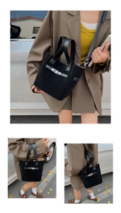 Detail of black matte leather bucket bag with silver twist lock and crossbody strap