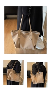 Detail of minimalist beige tote bag with litchi grain texture and secure zipper closure