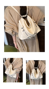 Detailed view of cream-white leather backpack with metal zippers and adjustable straps
