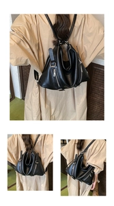 Detail view of the soft pebble grain texture and silver zipper of this chic black tote bag