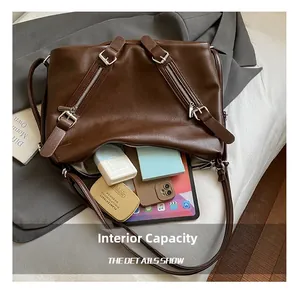Detail view of large capacity dark brown tote bag interior with multiple compartments