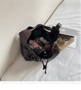 Deep brown bucket bag interior showing large capacity for umbrella and daily essentials