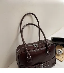 Detail of vintage brown tote bag with double zippers and stylish metal eyelet straps