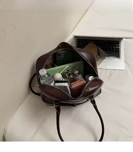 Top view of large brown patent leather tote bag showing spacious interior with essentials