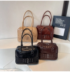 Detail view of four vintage faux leather handbags in beige, red-brown, black and coffee colors