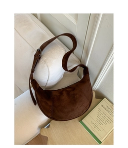 Close-up of matte dark brown suede hobo bag detailing soft texture and shoulder strap