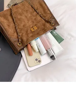 Detailed interior of brown suede tote bag showing spacious capacity for cosmetics