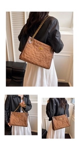 Close-up of brown quilted suede tote bag featuring gold chain strap and turn-lock closure
