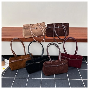 Détails de grands sacs cabas en daim présentés en six couleurs élégantes sur un plateau