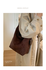 Brown suede tote bag shown on model's shoulder for large capacity daily commuting