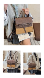 Detail of vintage brown suede stitching and metal buckle on fashionable crossbody bag