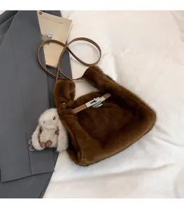 Brown faux fur handbag with leather strap and a cute white bunny charm accessory