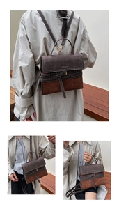 Close-up of retro color-block bag showing dual-texture leather and decorative buckles