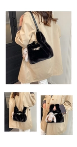 Detail of black fluffy tote with bunny ear handles and a white rabbit charm accessory