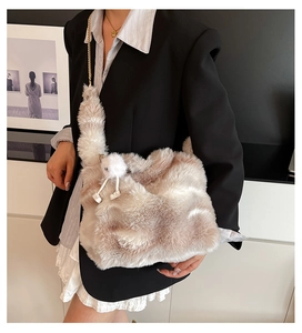 Detail of soft beige and white faux fur shoulder bag with elegant gold chain strap