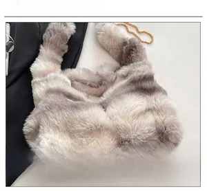 Detail showing the plush faux fur texture and golden metal chain of the winter tote bag