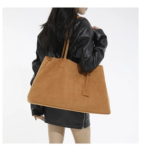 Macro detail of camel suede tote bag showing large capacity and fine texture