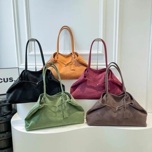 Large suede tote bag collection in five solid colors on a tiered white display stand