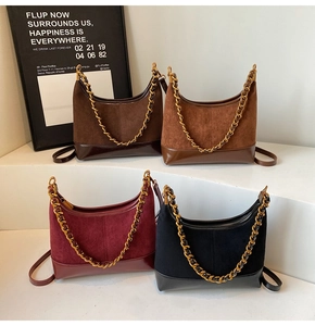 Chic dumpling bags in coffee, tan, burgundy, and black suede with gold chain strap details
