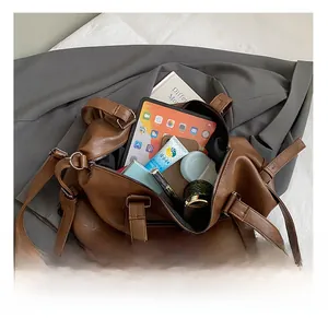 Detail showing spacious interior of the brown leather tote bag with daily essentials