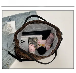 Top view of large leopard print tote bag interior with striped lining and high capacity