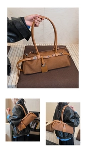 Detail of brown cylinder shoulder bag featuring suede texture and decorative buckle strap