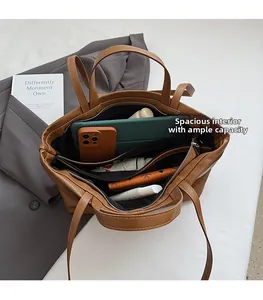 Detailed interior of a large brown tote bag showing spacious compartments and storage capacity