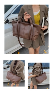 Detail of a large brown leather tote bag with elegant vertical stitching and dual straps
