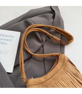 Détail du sac bandoulière en daim marron avec franges bohèmes et fine bandoulière réglable