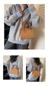 Macro detail of vintage brown suede shoulder bag with elegant gold metal square buckle lock