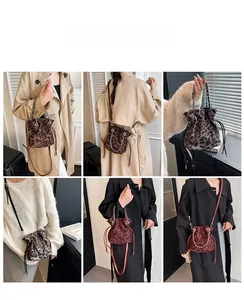 Detail view of leopard print bucket bag showing drawstring closure and chain handle