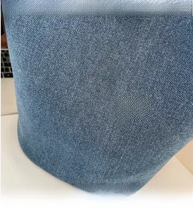 Close-up of premium blue denim fabric texture and twill pattern on bucket bag