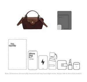 Detail view of small crossbody bag showing adjustable strap and inner mobile phone capacity