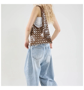 Macro view of brown leather tote bag featuring stylish silver metal rivet decorations