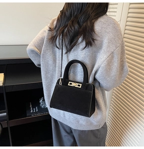 Chic black matte suede handbag shown on shoulder for professional office work commute