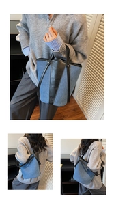 Detail of light blue denim bucket bag with black leather trim shown in a lifestyle setting