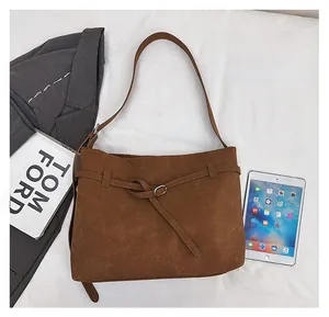 Brown suede tote bag size comparison with tablet and books for daily commute