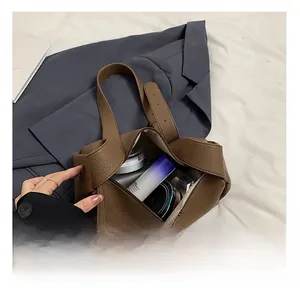 Internal view of brown leather bag showing spacious lining for cosmetics and accessories