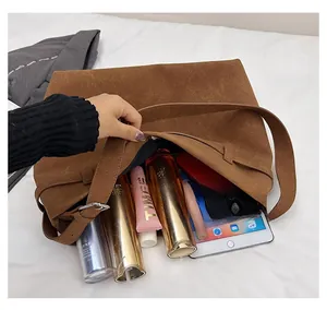 Spacious interior of brown suede tote bag showing large capacity for essentials