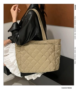 Detail of khaki quilted tote bag featuring large diamond stitching and soft padded nylon