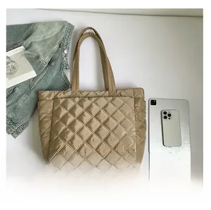 Flat lay of khaki quilted tote bag with diamond stitching and daily life accessories