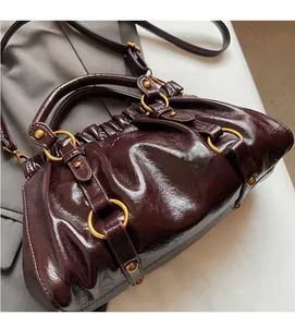 Detailed macro view of retro pleated dark reddish brown oily leather tote bag texture