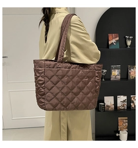 Close-up of the brown quilted tote bag showing detailed diamond stitching and puffy nylon texture
