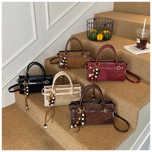 Detailed display of vintage Boston baguette bags in five colors with beaded tassels