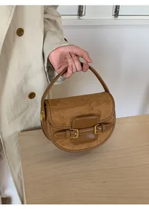 Detail showing high-quality brown suede and leather stitching with white decorative stitching