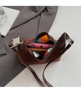 Top view of suede bucket bag interior showing spacious storage for cosmetics and wallet