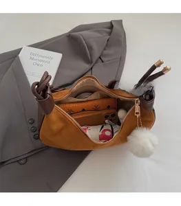 Top-down view of a crescent bag showing interior space for phone, umbrella, and accessories