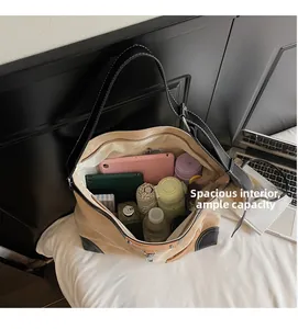 Top view showing spacious interior of khaki suede tote bag with daily essentials